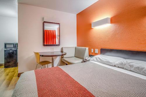 a hotel room with a bed and a table at Motel 6-Conroe, TX in Conroe