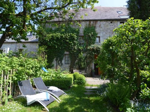 two lounge chairs in the garden of a house at Enchanting Cottage in Comblain Fairon with Terrace Garden in Hamoir