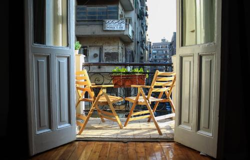 a balcony with a table and chairs on a balcony at Kmt Hostel in Cairo