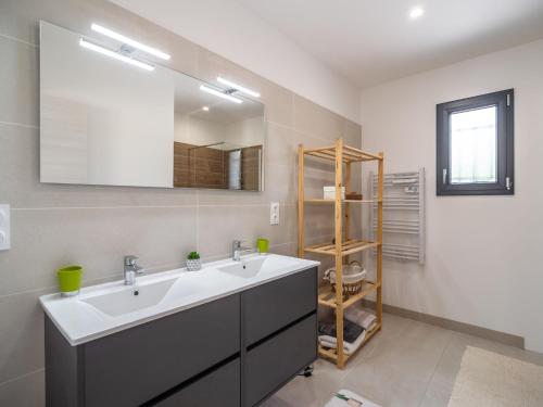 a bathroom with a sink and a mirror at Holiday Home Beaufort with Private Pool in Beaufort