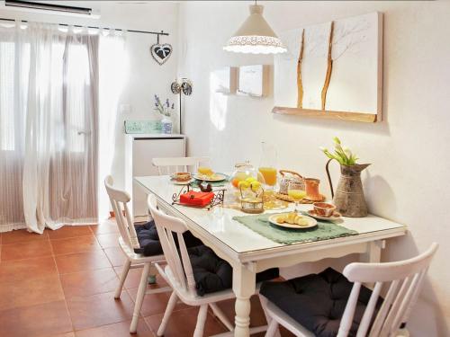 a dining room table with food and drinks on it at Cozy Apartment Brela in Brela