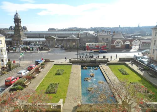 a view of a town with a fountain in a city at Admiral Guest House in Scarborough