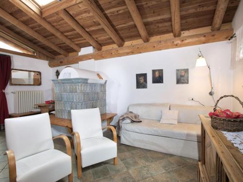 a living room with a couch and two chairs at Apartment in a typical baita in the Dolomites with sauna and Turkish bath in Bellamonte