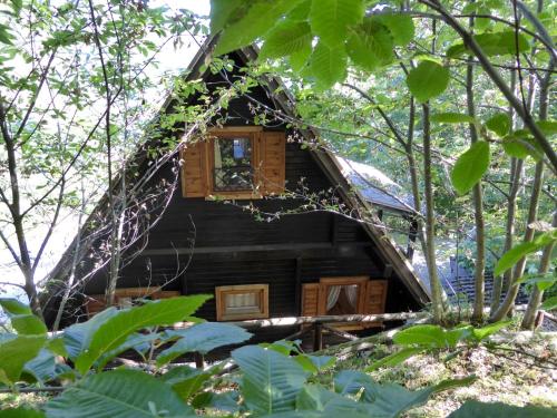 a tree house with a window in the woods at Belvilla by OYO Chalet Appennino in Cutigliano