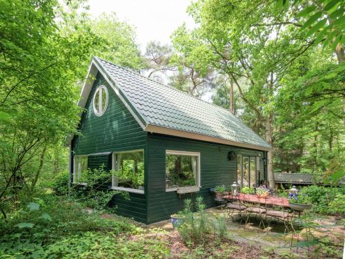 a green tiny house in the woods at Tranquil Holiday Home in Dalfsen with Fenced Garden in Dalfsen