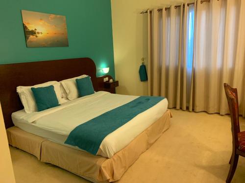 a bedroom with a large bed in a room at Al Wadi Hotel in Sohar