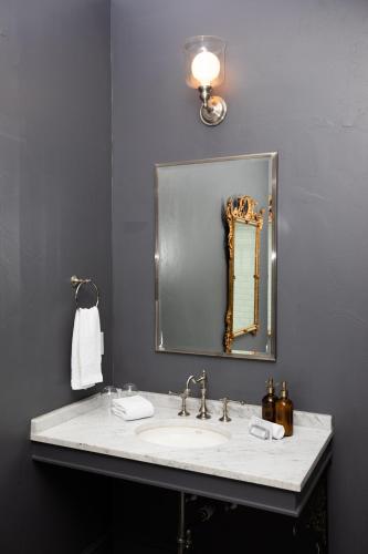 a bathroom with a sink and a mirror at Surf Hotel & Chateau in Buena Vista