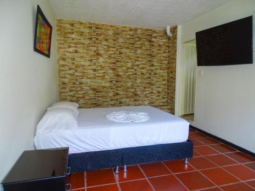 Postel nebo postele na pokoji v ubytování Hotel villa de Rauzan