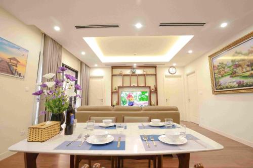 a living room with a table and a couch at *BOM HOMES* IMPERIA GARDEN RESIDENCE APARTMENT in Hanoi