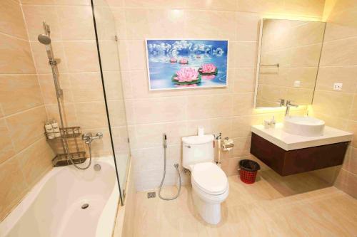 a bathroom with a toilet and a sink and a shower at *BOM HOMES* IMPERIA GARDEN RESIDENCE APARTMENT in Hanoi