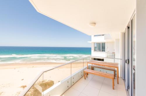 a balcony with a bench overlooking the beach at Berkeley on the Beach in Gold Coast