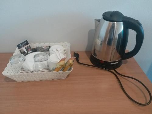 a coffee maker and a basket of food on a table at Saney Apartment in Ban Nong Ka Cha