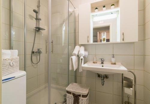 a bathroom with a shower and a sink and a mirror at Apartment Meri Jarun - near lake in Zagreb