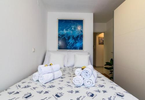 a bedroom with a bed with towels on it at Apartment Meri Jarun - near lake in Zagreb