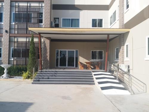 a building with stairs in front of a building at Saney Apartment in Ban Nong Ka Cha