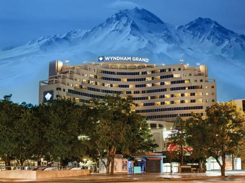 a hotel with a mountain in the background at Wyndham Grand Kayseri in Kayseri