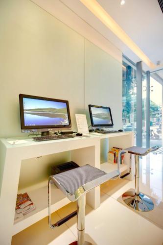a room with a desk with a computer on it at Ambience Hotel Taipei in Taipei