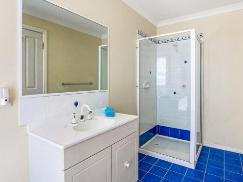 a white bathroom with a sink and a shower at Blue Jetty in Sunset Strip