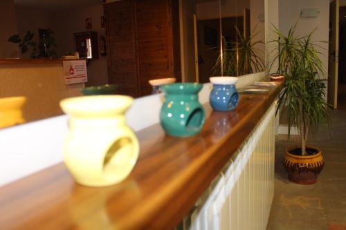 a counter with three vases sitting on top of it at Hotel Seva in Seva