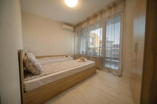a bedroom with a bed and a large window at Old Town Apartment in Plovdiv