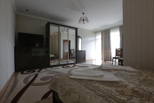 a bedroom with a large bed and a large mirror at Hotel Ashad in Svalyava