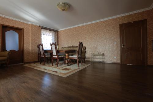 an empty living room with a table and chairs at Hotel Ashad in Svalyava
