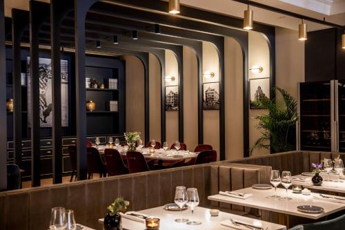 a dining room with tables and chairs and lights at Radisson Blu Royal Viking Hotel, Stockholm in Stockholm