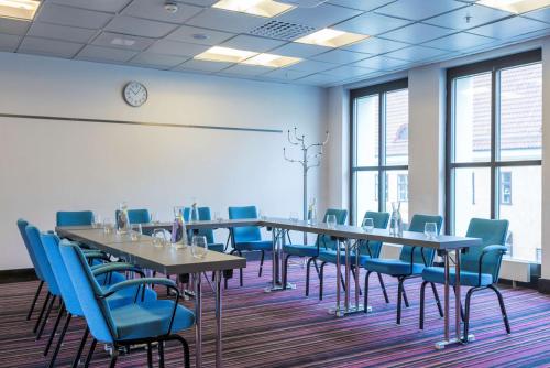a conference room with tables and chairs and a whiteboard at Radisson Blu Hotel Malmö in Malmö