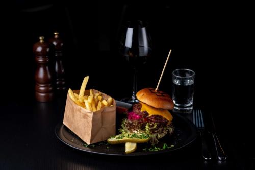 a plate of food with a sandwich and french fries at Radisson Blu Hotel Malmö in Malmö