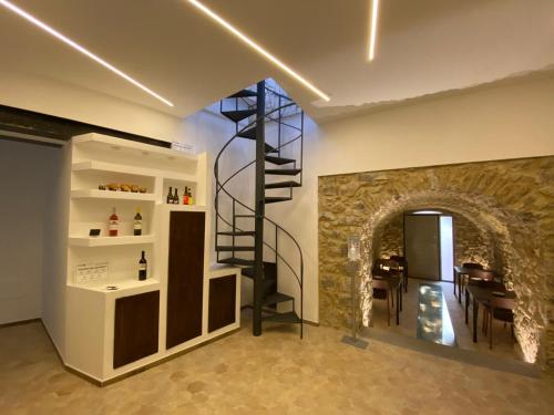 a wine cellar with a spiral staircase in a room at L'Orologio Bed & Breakfast in Capaccio-Paestum