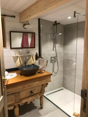a bathroom with a sink and a shower at Chalet du praillage in Spa