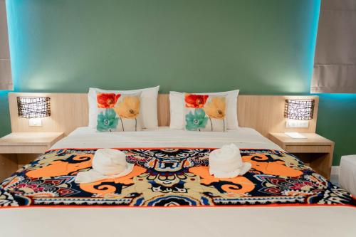 a bedroom with a bed with towels on it at It's me Keawanong Hotel in Nakhon Ratchasima
