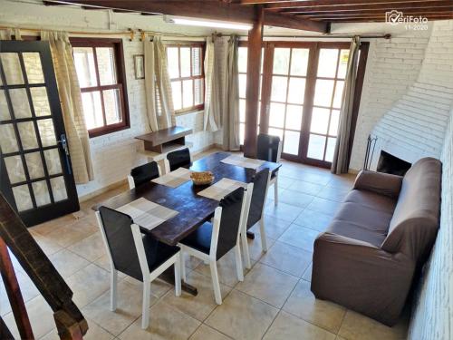a living room with a table and a couch at Cabañas Barra Linda in Barra del Chuy