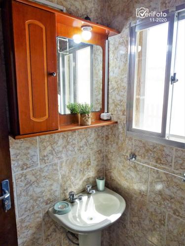 a bathroom with a sink and a mirror at Cabañas Barra Linda in Barra del Chuy