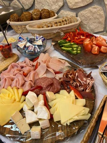 a table with many different types of meats and cheese at hotel Nautilus in Chodov