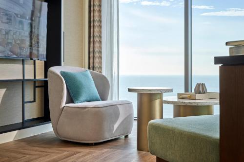 a chair and a table in a room at Grand Josun Busan in Busan