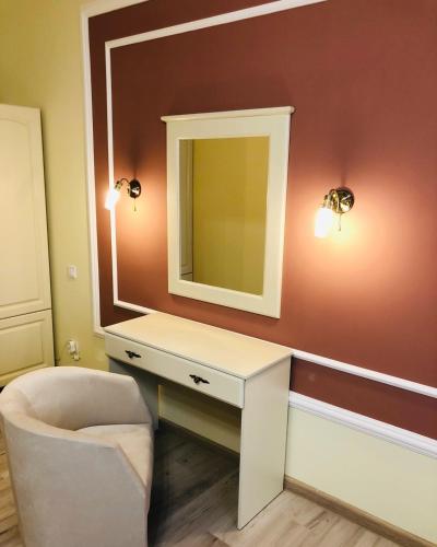 a bathroom with a mirror and a sink and a chair at Royal Rest 