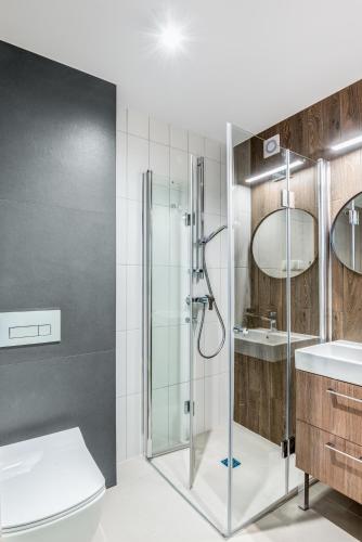a bathroom with a shower and a toilet and a sink at OSW Posejdon Kołobrzeg in Kołobrzeg