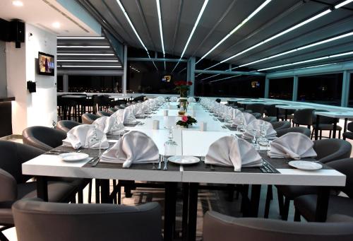 a long dining room with a long table and chairs at BUSINESS HOTEL SFAX in Sfax