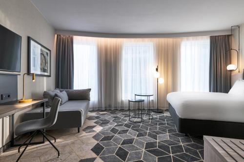 a hotel room with a bed and a couch at Crowne Plaza - Warsaw - The HUB by IHG in Warsaw
