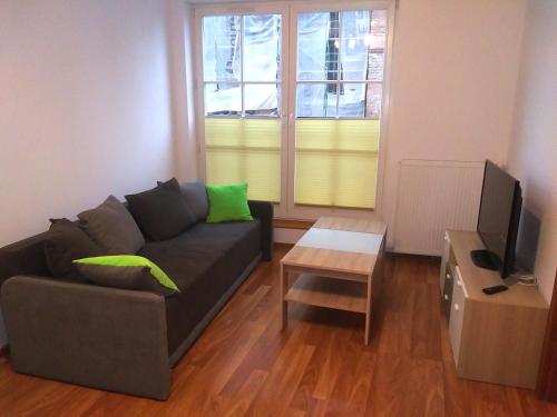 a living room with a couch and a television at Apartment Old Town Cozy in Elblag