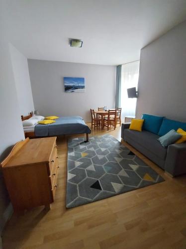 a living room with a couch and a table at Hotelik Gołdap in Gołdap