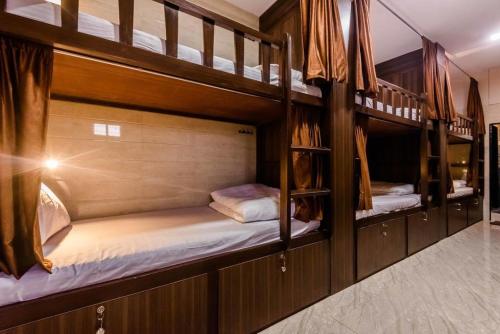 a couple of bunk beds in a room at Awesome Dormitory Male Only in Mumbai
