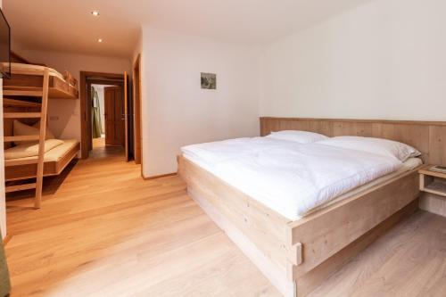 a bedroom with a bed and a bunk ladder at Kramerl in Bruck an der Großglocknerstraße