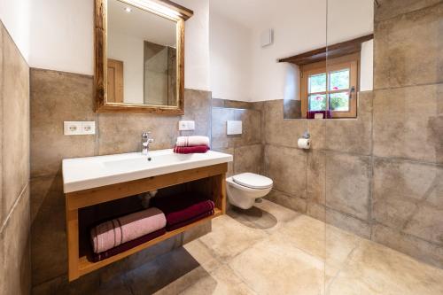 a bathroom with a sink and a toilet at Kramerl in Bruck an der Großglocknerstraße