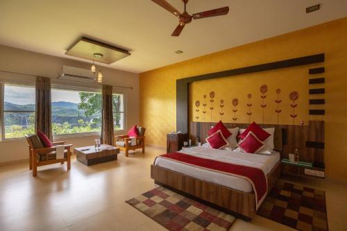 a bedroom with a large bed and a large window at KSTDC Hotel Mayura Gerusoppa, Jogfalls in Māvingundi