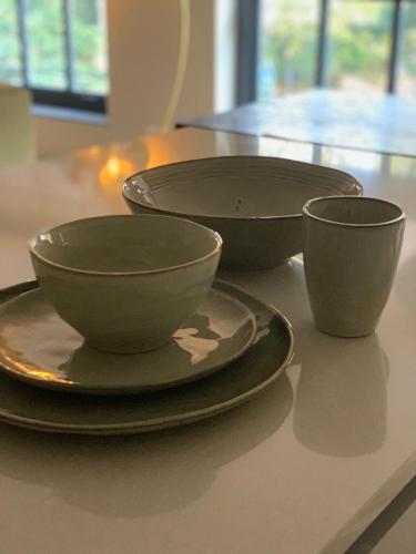 three bowls and plates sitting on a table at Parkhotel Abcoude in Abcoude
