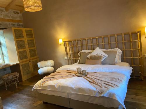 a bedroom with a large bed with a wooden headboard at Perlacia Hotel Adatepe in Adatepe