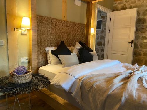 a bedroom with a large bed with white sheets at Perlacia Hotel Adatepe in Adatepe