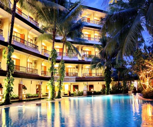 a hotel with a swimming pool in front of a building at Le Dian Hotel in Serang